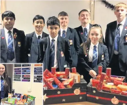  ??  ?? Christmas hampers have been donated by students at Haslingden High School. Form 10M hampers and, left, Year 10 Katie Gent