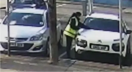  ??  ?? What a fine mess: The officer is caught on CCTV apparently replacing a ticket with a penalty notice