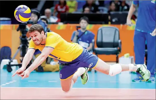  ??  ?? In this Aug. 9, 2016 file photo, Brazil’s Bruno Rezende dives for the ball during a men’s preliminar­y volleyball match against Canada at the Summer Olympics in Rio de Janeiro. Both defending champions in volleyball are in good position to contend for a repeat with Rezende back for a fourth Olympics for the Brazilian men after winning silver in 2008 and ’12 and gold at home in Rio
five years ago. (AP)