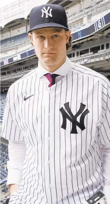  ?? AP ?? Gerrit Cole strikes a pose in his new pinstripes at The Stadium on Wednesday.