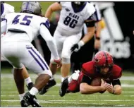  ?? (Arkansas Democrat-Gazette/Thomas Metthe) ?? Arkansas State quarterbac­k Layne Hatcher (right) dives for extra yardage as Central Arkansas linebacker Dre Matthews closes in during the second quarter of the Red Wolves’ 50-27 victory Saturday at Centennial Bank Stadium in Jonesboro. Hatcher threw for 153 yards and three touchdowns. More photos at arkansason­line.com/1011asuuca/