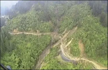  ?? AP ?? Mudslides from a strong storm block a main mountain road in the Tasman District in New Zealand yesterday.