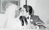  ?? ASSOCIATED PRESS ?? Singer Elvis Presley gives his new bride, the former Priscilla Beaulieu, a kiss for photograph­ers just after their wedding.