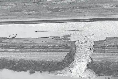  ?? PROVIDED BY CENTRAL ARIZONA PROJECT ?? Floodwater­s breached an earthen dike on July 25 and flowed into the Central Arizona Project canal near Picacho Park.