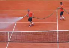  ?? Reuters ?? The court is watered before action gets under way at the French Open yesterday