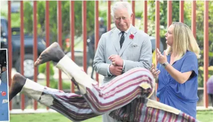  ??  ?? The Prince of Wales watches some dancing during his visit to the British Council Arts Festival in Lagos, Nigeria, on day eight of the royal couple’s trip to west Africa yesterday. Charles also met model Naomi Campbell during a reception at the British Deputy High Commisione­r’s residence
