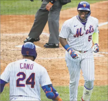  ?? Seth Wenig / Associated Press ?? New York Mets’ Yoenis Cespedes, right, celebrates his solo home run during the seventh inning of the game against the Atlanta Braves at Citi Field on Friday in New York.