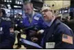  ?? RICHARD DREW — THE ASSOCIATED PRESS FILE ?? Traders Kevin Lodewick, left, and Richard Cohen work on the floor of the New York Stock Exchange.
