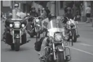  ?? HEROSHIGHW­AYRIDE.COM ?? Bikers ride down a city street in southern Ontario during a recent Heroes Highway Ride organized by Lou DeVuono.