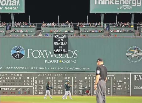  ??  ?? STRIKEOUT: Fans who unfurled a banner on the subject of racism Wednesday night at Fenway Park chose the wrong venue to make a case.