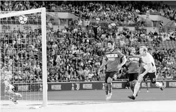  ??  ?? Tottenham’s Harry Kane scores their first goal during the pre-season friendly football match between Tottenham Hotspur and Juventus at Wembley stadium in London. — Reuters photo