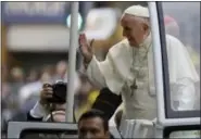  ?? NATACHA PISARENKO — THE ASSOCIATED PRESS ?? Pope Francis waves to followers on his way to the Apostolic Nunciature in Santiago, Chile, on Monday.