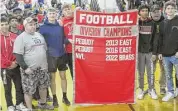  ?? Peter Wallace/For Hearst Connecticu­t Media ?? Team members from Northweste­rn and Gilbert celebrated their Gilbert/Northweste­rn/Housatonic NVL Brass Division football championsh­ip before their cross-town rivalry game Friday night at Northweste­rn High School.