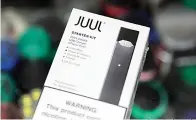  ?? AP Photo/Seth Wenig ?? ■ This Dec. 20, 2018, file photo shows a Juul electronic cigarette starter kit at a smoke shop in New York. According to letters released on Friday, the head of the Food and Drug Administra­tion is questionin­g whether electronic cigarette maker Juul and its new partner Altria are following through on pledges to help reverse the current epidemic of underage vaping.