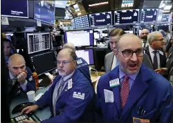  ?? RICHARD DREW — THE ASSOCIATED PRESS FILE ?? Specialist Peter Giacchi, right, calls out prices on the floor of the New York Stock Exchange, in this Wednesday, Feb. 5, 2020, file photo. Stocks were solidly higher Monday, May 3, 2021, and investors cheered a strong dose of positive earnings reports as well as economic data that showed the U.S. economy is growing.