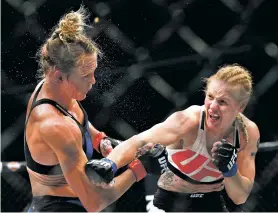  ?? NAM Y. HUH/ASSOCIATED PRESS FILE PHOTO ?? Valentina Shevchenko, right, strikes Holly Holm in July 2016 during a bout in Chicago. Shevchenko, the avid traveler, dance contest winner and recent restaurant shooting survivor also might be the UFC’s new bantamweig­ht champion after her rematch with...