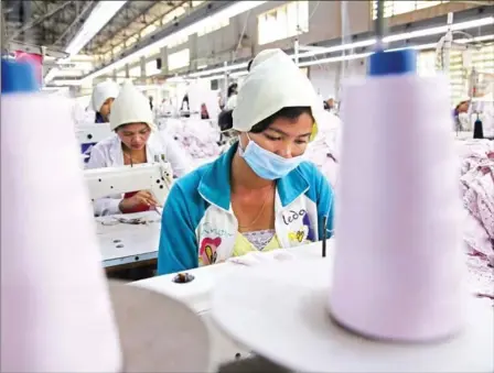  ?? HONG MENEA ?? Garment workers in Phnom Penh’s Sen Sok district in 2017. The withdrawal of the EU’s Everything But Arms trade preference­s from Cambodia is likely to hit the garment factory sector hardest.