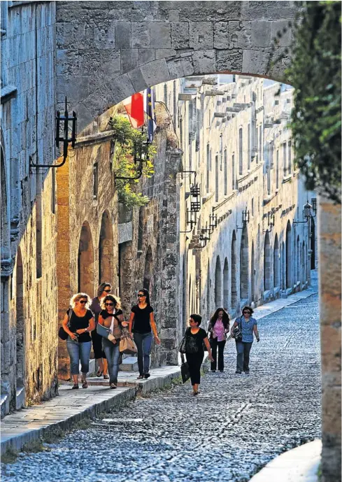  ?? Pictures: GREATSTOCK/CORBIS ?? COBBLE ME UP: Strolling through the beautiful medieval old town of Rhodes