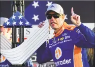  ?? Scott Cunningham / Associated Press ?? Brad Keselowski poses with the trophy after winning the NASCAR Monster Energy Cup Series race Sunday at Atlanta Motor Speedway in Hampton, Ga.