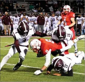  ?? PILOT PHOTO/ MAGGIE NIXON ?? Quentin Crawford looks on while Collin Mills gets some hard earned yardage as the Rockies fell to Mishawaka.