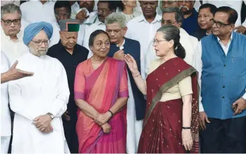  ?? — AFP ?? Meira Kumar (C) listens as Congress Party President Sonia Gandhi speaks before filing her nomination papers at Parliament House in New Delhi on Wednesday.