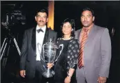  ??  ?? In this file picture Roy Moodley, left, holds the trophy being the KwaZulu-Natal Owner of the Year. He was pictured with his wife Mumsy and son Selvan.