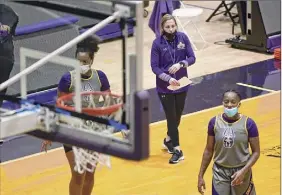  ?? Lori Van Buren / Times Union ?? Ualbany women's basketball coach Colleen Mullen, center, says that while Maine and Stony Brook are best, there’s parity in the America East.