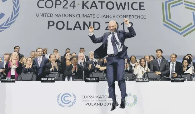  ??  ?? 0 Michal Kurtyka, who chaired the summit, jumps with delight at the end of its final session on climate change in Katowice on Saturday