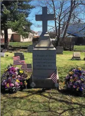  ?? KATHLEEN CAREY – DIGITAL FIRST MEDIA ?? The Eddystone Memorial at Chester Rural Cemetery is festooned with flowers and flags moments before Saturday’s commemorat­ion of the centennial of the blast that killed more than 100 in the borough.