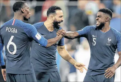  ?? AP PHOTO ?? France’s Samuel Umtiti, right celebrates with teammates Paul Pogba, left, and Adil Rami after defeating Belgium in their semifinal match at the 2018 soccer World Cup in St. Petersburg, Russia, Tuesday.