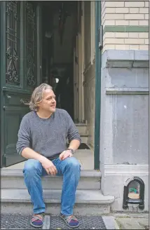  ??  ?? Stef Pottums sits on his step next to a miniature scene by Lemmens.