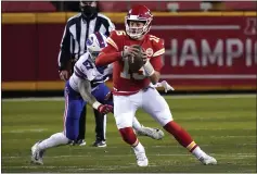  ?? JEFF ROBERSON — THE ASSOCIATED PRESS ?? Kansas
City Chiefs quarterbac­k Patrick Mahomes (15) scrambles ahead of Buffalo Bills defensive end A.J. Epenesa (57) during the first half of the AFC championsh­ip game Sunday in Kansas
City, Mo.