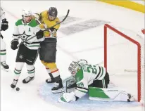  ?? RONDA CHURCHILL/THE ASSOCIATED PRESS ?? Dallas goaltender Jake Oettinger blocks a shot Saturday near Golden Knights center Brett Howden during the second period of Game 5 in Las Vegas, Nev. Oettinger had 27 saves.