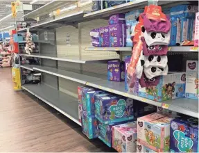  ?? KELLY TYKO/USA TODAY ?? Baby wipes were wiped out at a Walmart store in Stuart, Fla., on April 19 because of COVID-19.