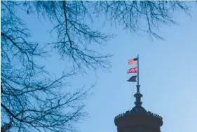  ?? AP PHOTO/JOHN AMIS ?? Flags fly over the state capitol in February in Nashville.