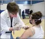  ?? BEN HASTY — READING EAGLE ?? Natlie Lawton receives a dose of the Moderna vaccine from Deborah Greenawald in Reading during a recent COVID-19 vaccine clinic.