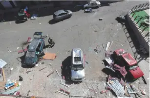  ?? ( Reuters) ?? DAMAGED CARS are seen on a street in Stepanaker­t on Sunday during the military conflict over the breakaway region of Nagorno- Karabakh.