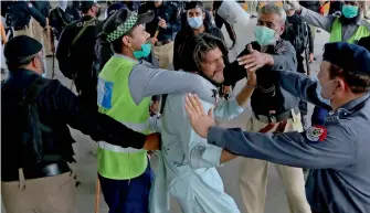  ?? Reuters ?? Policemen detain a supporter of Tehreek-e-labbaik Pakistan during a protest against the arrest of their party leader, Saad Rizvi, in Peshawar. —