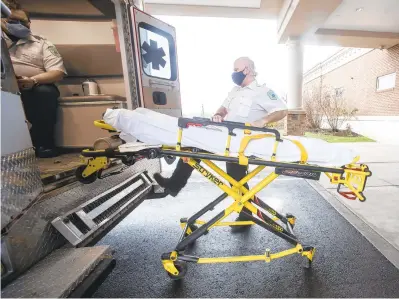  ?? RICKKINTZE­L/THE MORNING CALL ?? Joe Berger, an EMT for Suburban EMS, loads the ambulance’s gurney Saturday after a run to St. Luke’s Hospital-Anderson Campus in Bethlehem Township.