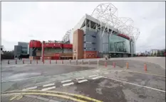  ?? AP PHOTO/JON SUPER ?? Almost empty stadium area around Manchester United’s Old Trafford Stadium, on Saturday, where Manchester City was due to play Burnley in an English Premier League soccer match, after all English soccer games were cancelled due to the spread of the COVID-19 Coronaviru­s.