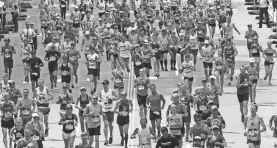  ?? AP ?? Runners head to the finish line of the 2017 Boston Marathon.