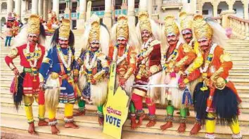  ?? PTI ?? ■ Artists pose for a photo during the filming of a song for the forthcomin­g Karnataka Assembly elections in front of Vidhanasou­dha in Bengaluru yesterday.