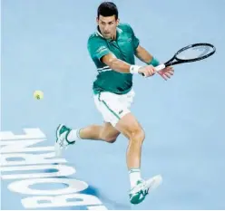  ?? Associated Press ?? ↑
Novak Djokovic hits a backhand return to Alexander Zverev (unseen) during their Australian Open quarter-final match in Melbourne on Tuesday.