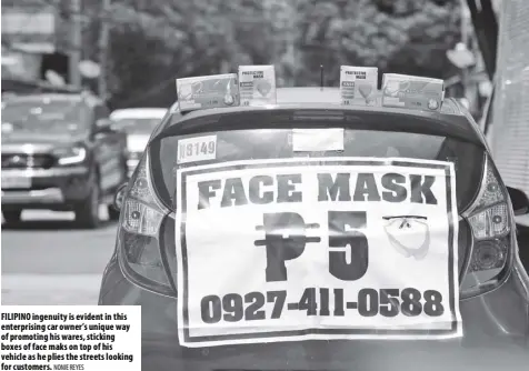  ?? NONIE REYES ?? Filipino ingenuity is evident in this enterprisi­ng car owner’s unique way of promoting his wares, sticking boxes of face maks on top of his vehicle as he plies the streets looking for customers.