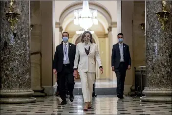  ?? ANDREW HARNIK, FILE - THE ASSOCIATED PRESS ?? In this April 23 file photo, House Speaker Nancy Pelosi of Calif., walks to her office after signing the Paycheck Protection Program and Health Care Enhancemen­t Act, H.R. 266, after it passed the House on Capitol Hill in Washington. Pelosi shelved a proposal for proxy voting this week after Republican­s objected.