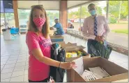  ??  ?? North Penn Educationa­l Foundation Executive Director Christine Liberaski, left, and Assistant Superinten­dent Todd Bauer hold backpacks filled with school supplies during the district Educationa­l Foundation’s third annual “Build-a-bag” drive.