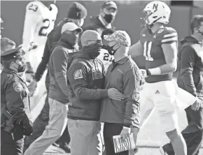  ?? NATI HARNIK/AP ?? Nebraska coach Scott Frost, right, meets with Penn State coach James Franklin following their game in Lincoln, Neb., on Saturday.