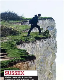  ?? ?? SUSSEX
Walker takes a look over the dangerous cllffs at Birling Gap