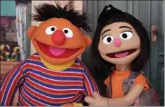  ?? NOREEN NASIR / AP ?? Ernie, a muppet from the popular children's series ‘Sesame Street,' appears with new character Ji-young, the first Asian American muppet, on the set of the long-running children's program.