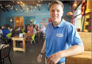  ?? Arkansas Democrat-Gazette/STATON BREIDENTHA­L ?? Austin Samuelson, owner of Tacos 4 Life, opened his first restaurant with his wife, Ashton, after the couple heard that 18,000 children worldwide die each day from hunger.
